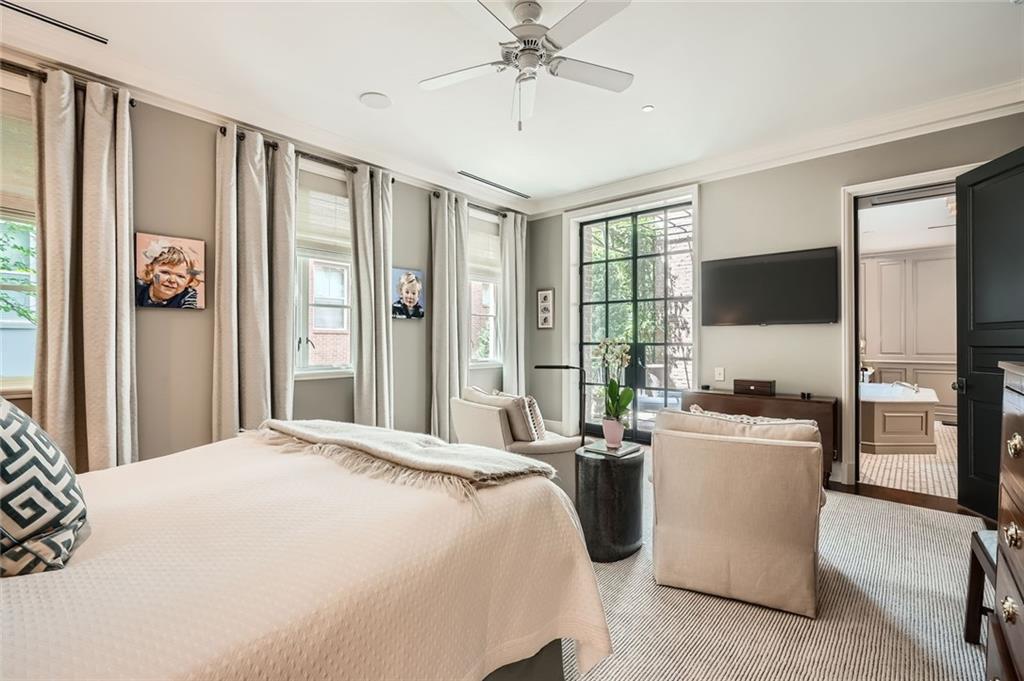 2440 Peachtree Road Northwest, Unit 9 Atlanta, GA 30305 - Photo 23 of 48 a bedroom with a bed flat screen tv and a large window