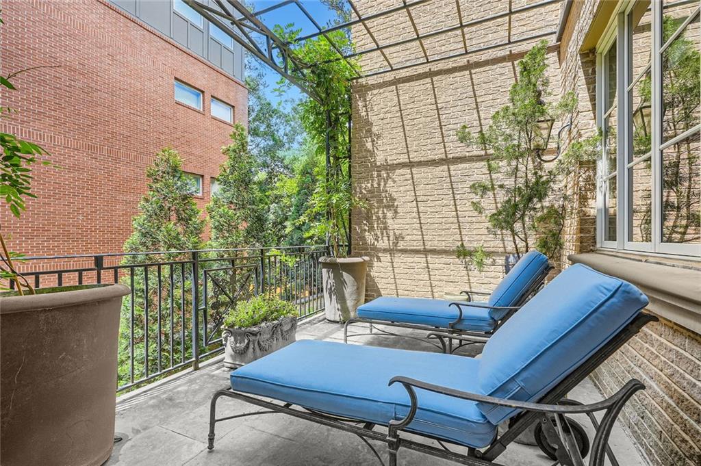 2440 Peachtree Road Northwest, Unit 9 Atlanta, GA 30305 - Photo 24 of 48 a view of a balcony with chairs and a table