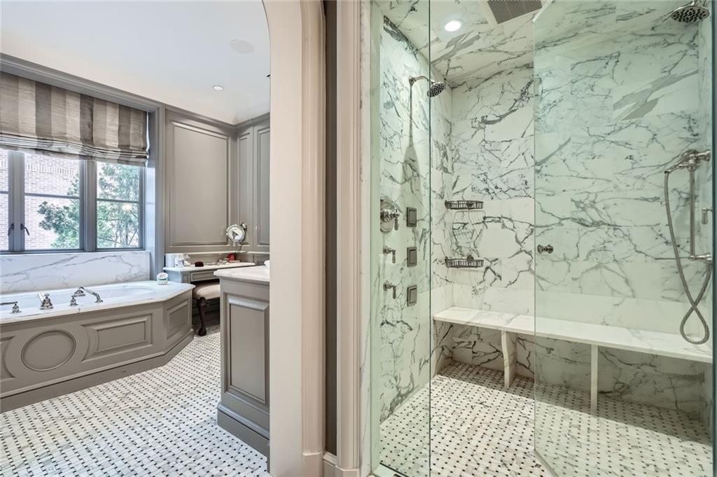 2440 Peachtree Road Northwest, Unit 9 Atlanta, GA 30305 - Photo 28 of 48 a bathroom with a sink a toilet a mirror and shower