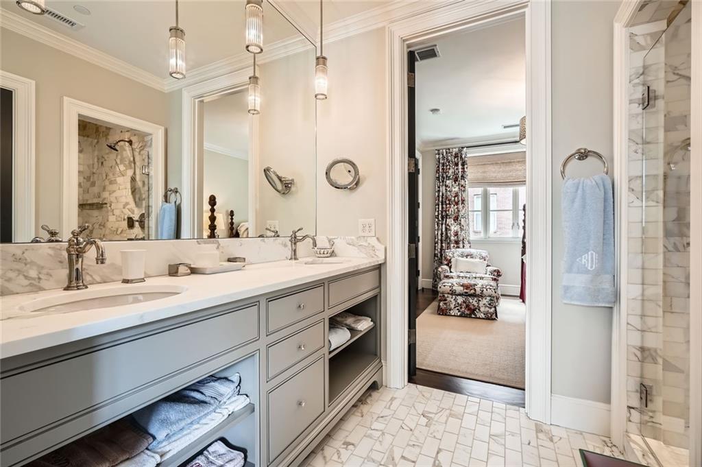 2440 Peachtree Road Northwest, Unit 9 Atlanta, GA 30305 - Photo 34 of 48 a spacious bathroom with a double vanity sink a mirror and shower