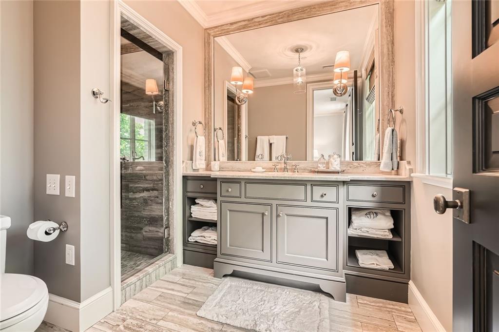 2440 Peachtree Road Northwest, Unit 9 Atlanta, GA 30305 - Photo 37 of 48 a bathroom with a sink a toilet and shower