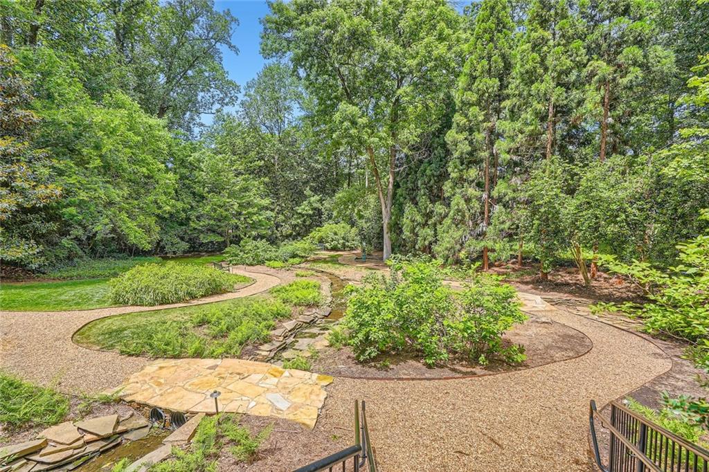 2440 Peachtree Road Northwest, Unit 9 Atlanta, GA 30305 - Photo 43 of 48 a view of a garden with a bench