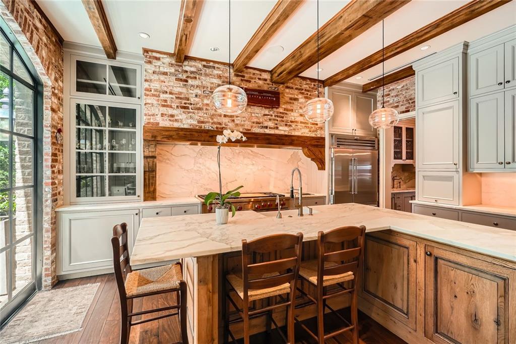 2440 Peachtree Road Northwest, Unit 9 Atlanta, GA 30305 - Photo 10 of 48 a dining area with granite countertop a sink and chairs