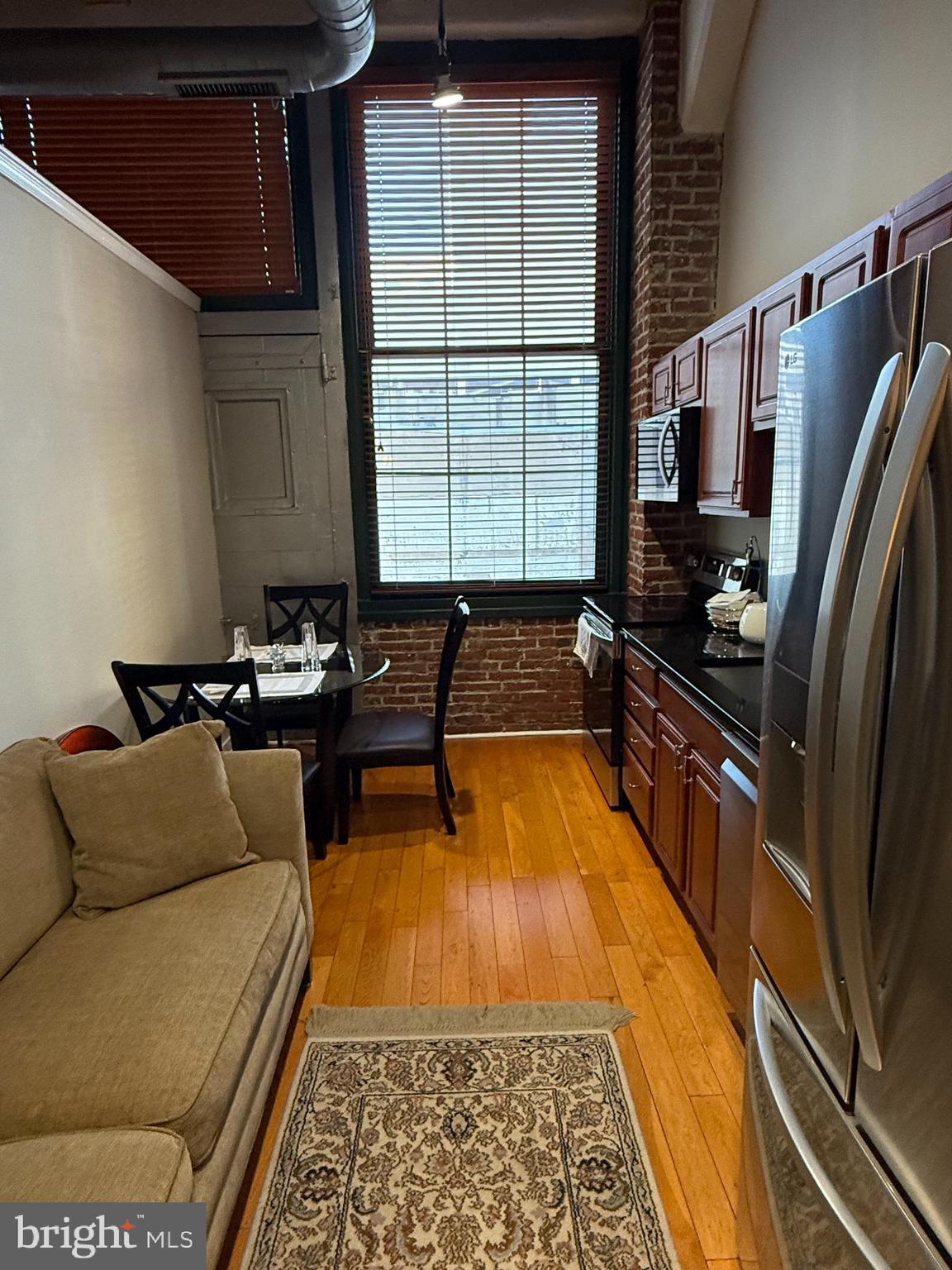 1010 Arch Street, Unit 304 Philadelphia, PA 19107 - Photo 7 of 10 a living room with furniture fireplace and a rug