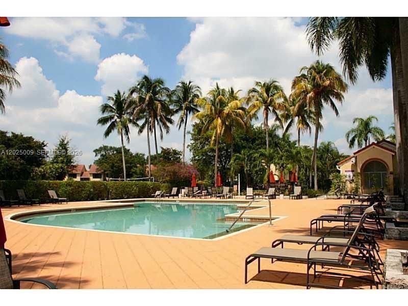 951 Lyons Road, Unit 6206 Coconut Creek, FL 33063 - Photo 17 of 27 a swimming pool with outdoor seating and yard
