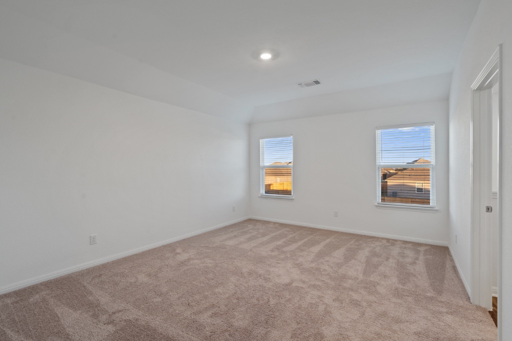 14013 John Aregood Pass Elgin, TX 78621 - Photo 13 of 31 an empty room with windows and mirror