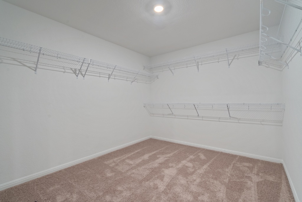 14013 John Aregood Pass Elgin, TX 78621 - Photo 18 of 31 a view of a room with racks on the wall