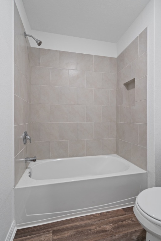 14013 John Aregood Pass Elgin, TX 78621 - Photo 24 of 31 a bathroom with a bathtub and a toilet