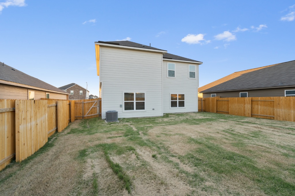 14013 John Aregood Pass Elgin, TX 78621 - Photo 31 of 31 a view of a house with a backyard