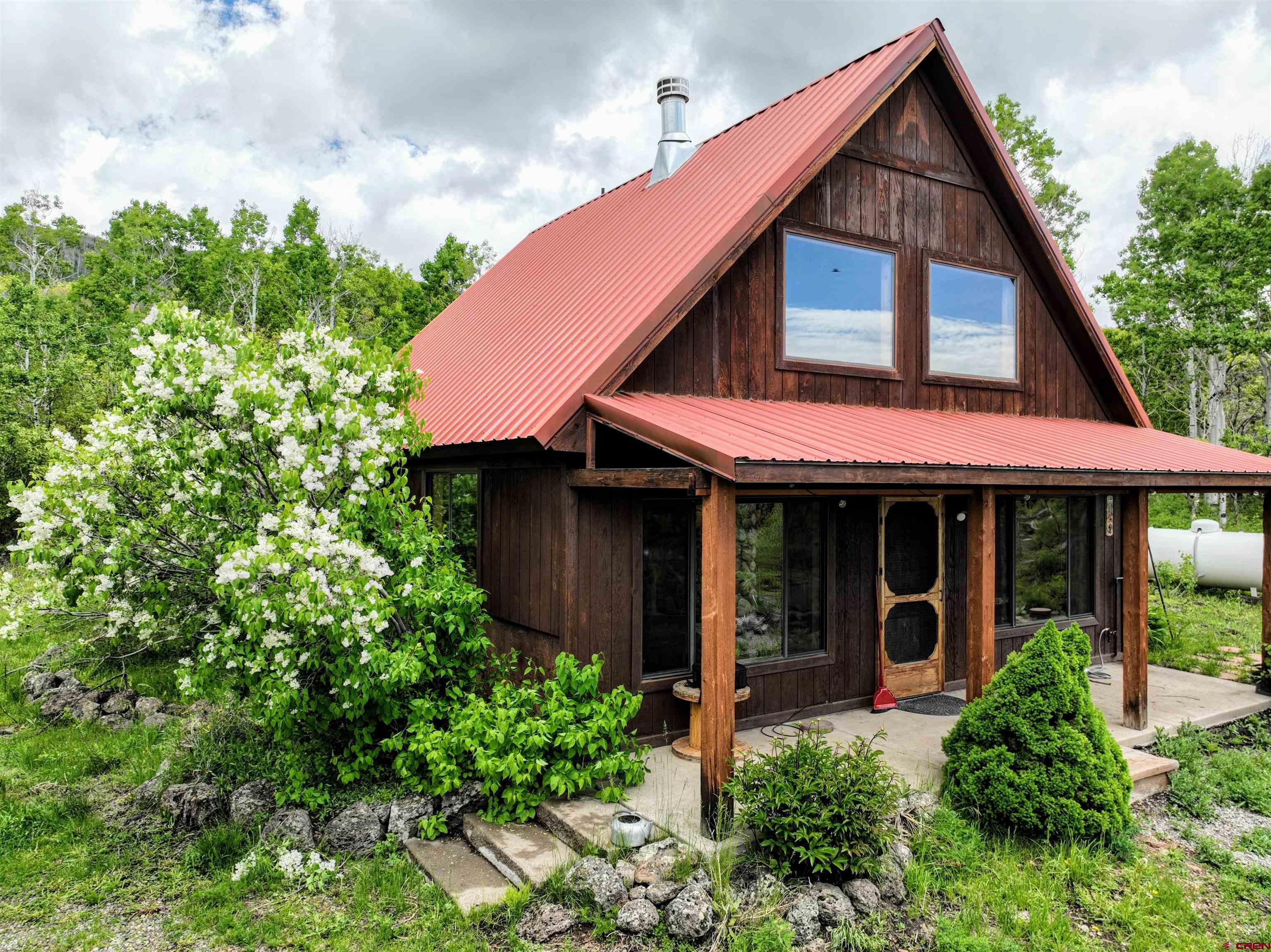 Lot 1 Aspen Hills Road Cedaredge, CO 81413 - Photo 1 of 32 a view of a house with potted plants and a yard