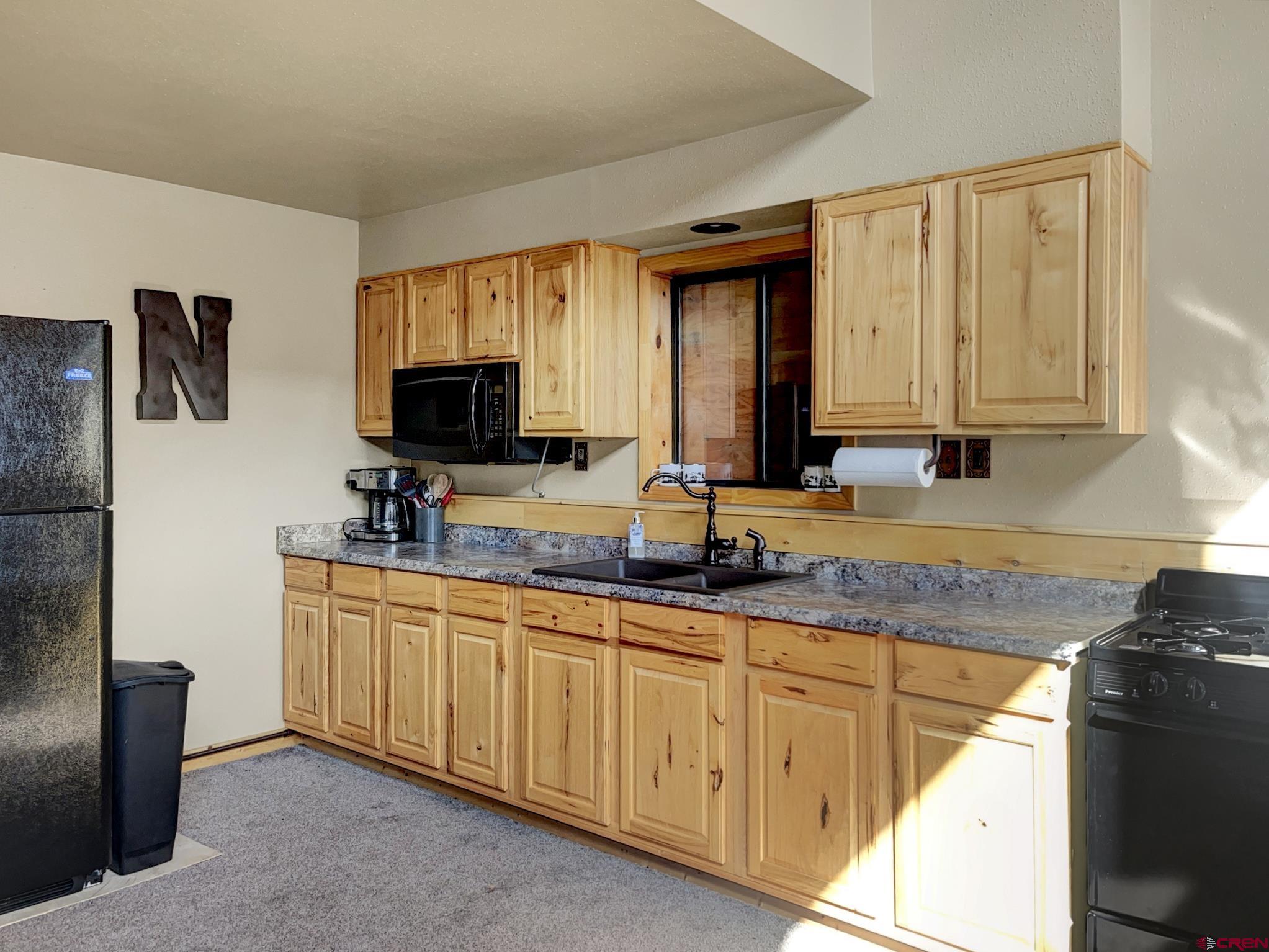 Lot 1 Aspen Hills Road Cedaredge, CO 81413 - Photo 12 of 32 a kitchen with stainless steel appliances granite countertop a sink stove and microwave