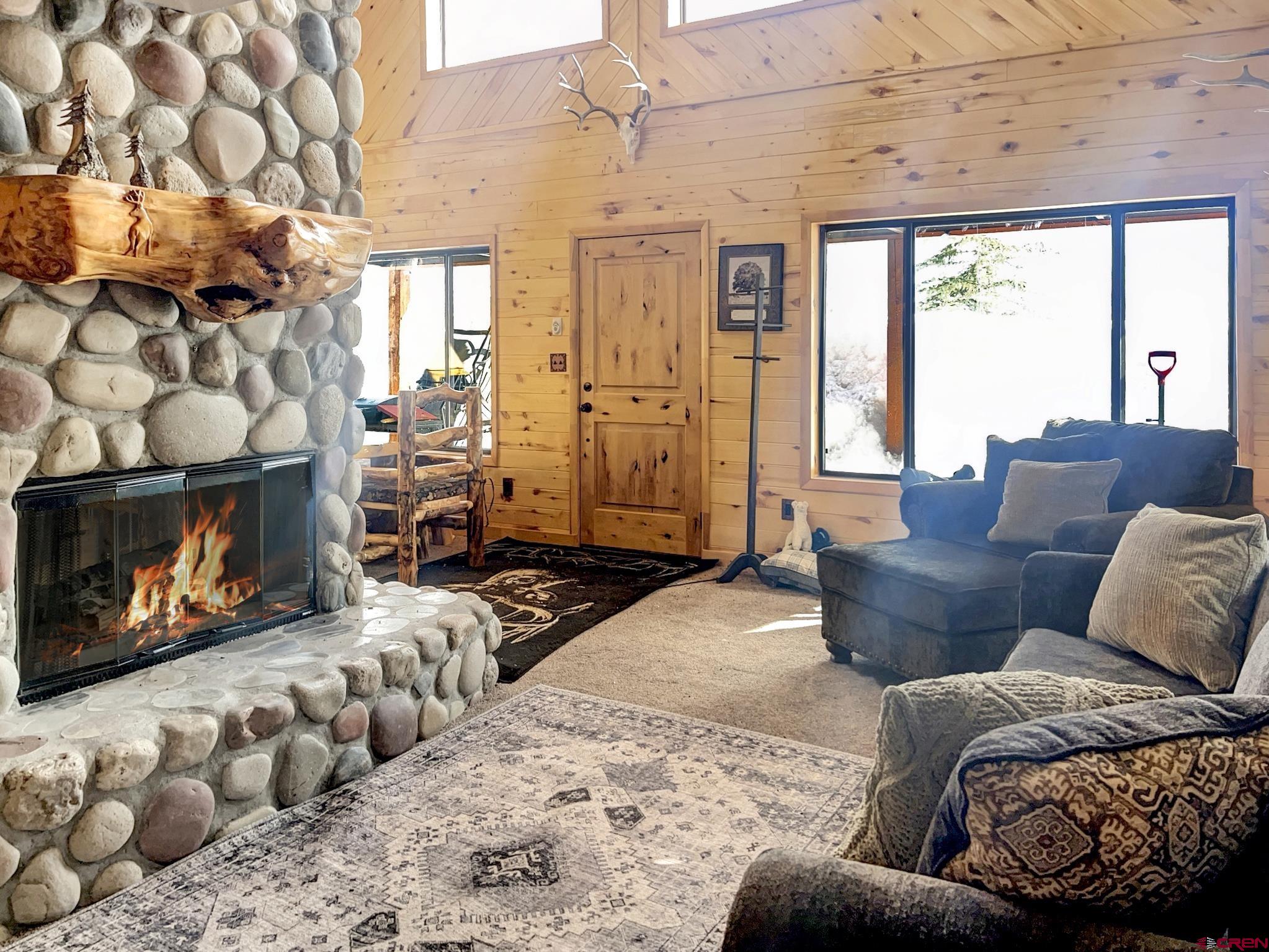 Lot 1 Aspen Hills Road Cedaredge, CO 81413 - Photo 18 of 32 a living room with furniture large window and a fireplace
