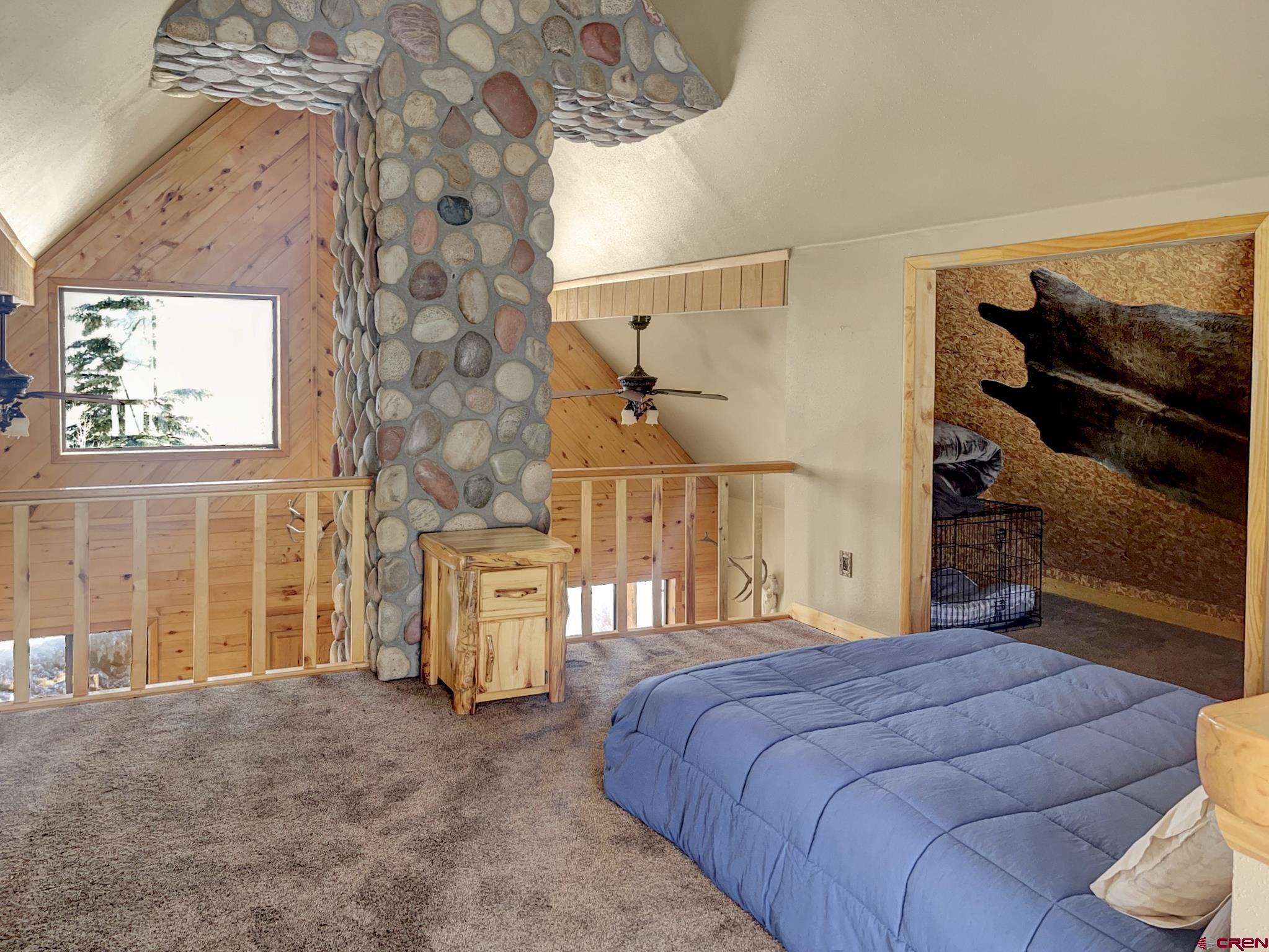 Lot 1 Aspen Hills Road Cedaredge, CO 81413 - Photo 22 of 32 a bedroom with a large bed and a window