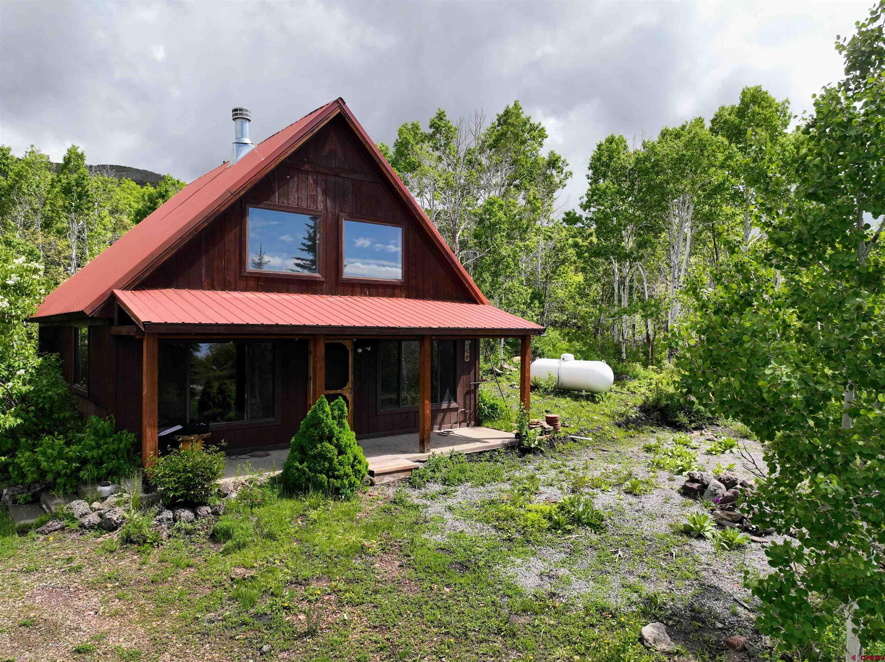 Lot 1 Aspen Hills Road Cedaredge, CO 81413 - Photo 31 of 32 a front view of house with yard outdoor seating and green space