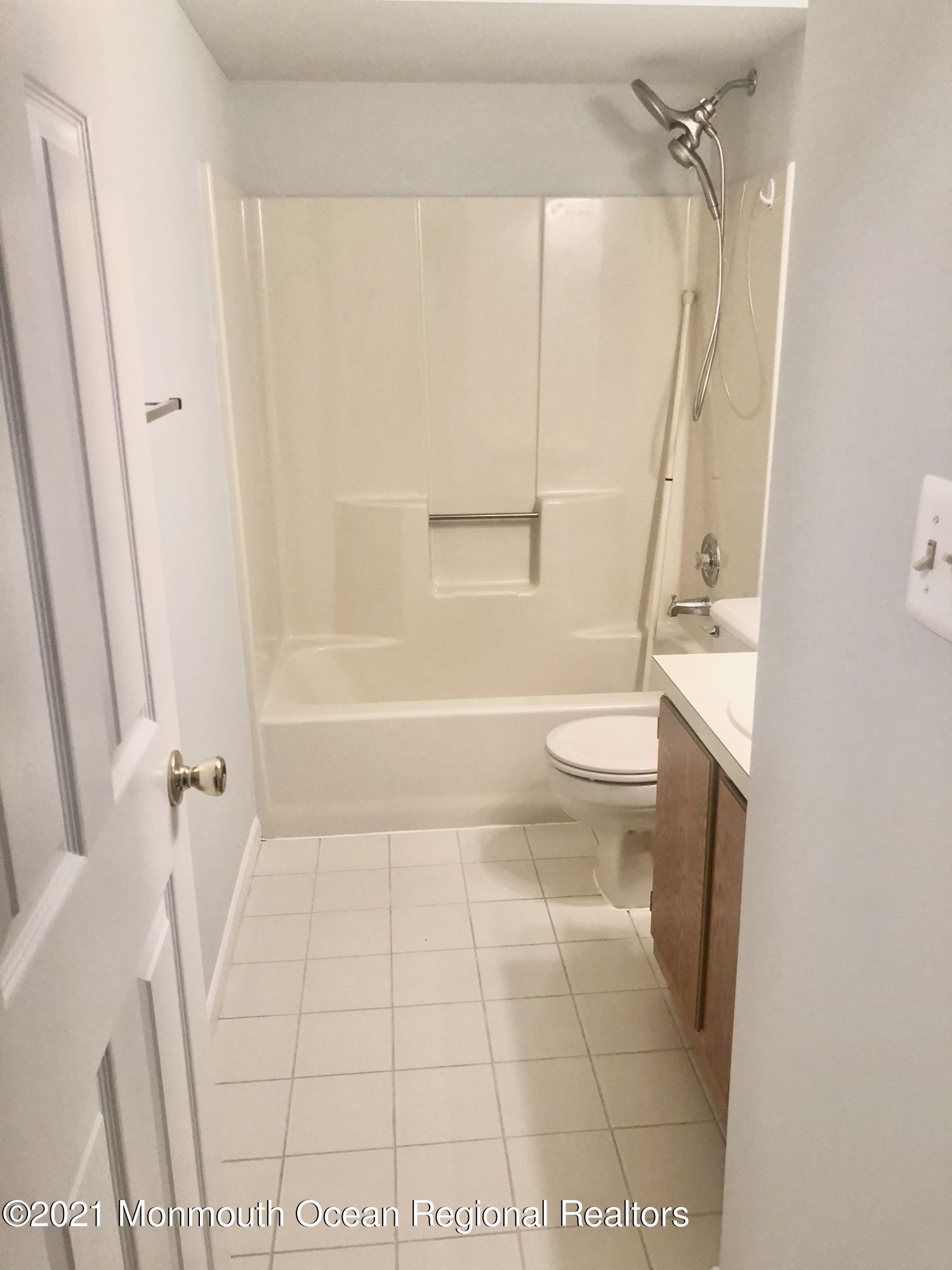 5 Racquet Road Wall, NJ 07719 - Photo 13 of 21 a bathroom with a toilet and a shower