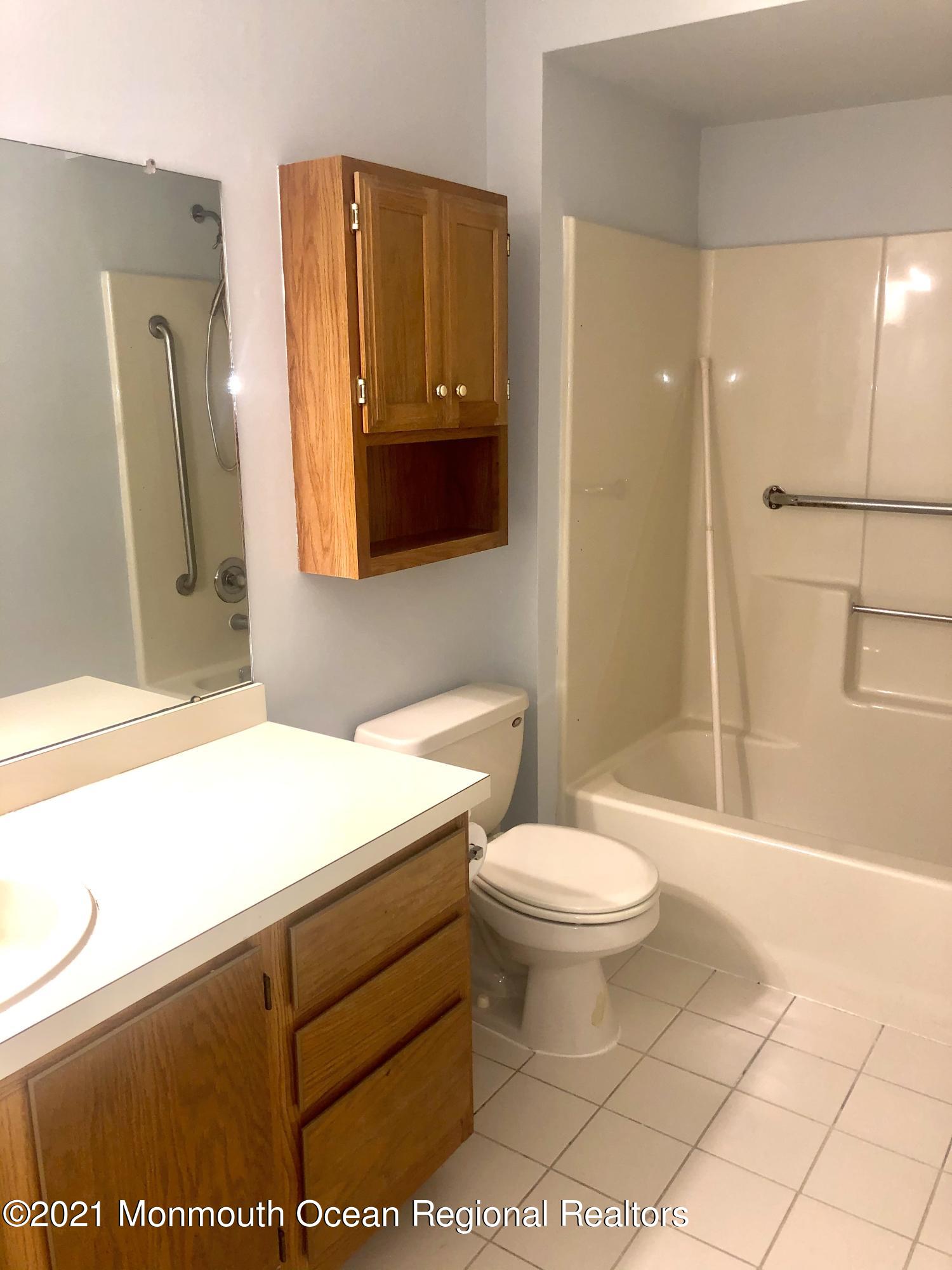 5 Racquet Road Wall, NJ 07719 - Photo 19 of 21 a bathroom with a sink a toilet and shower