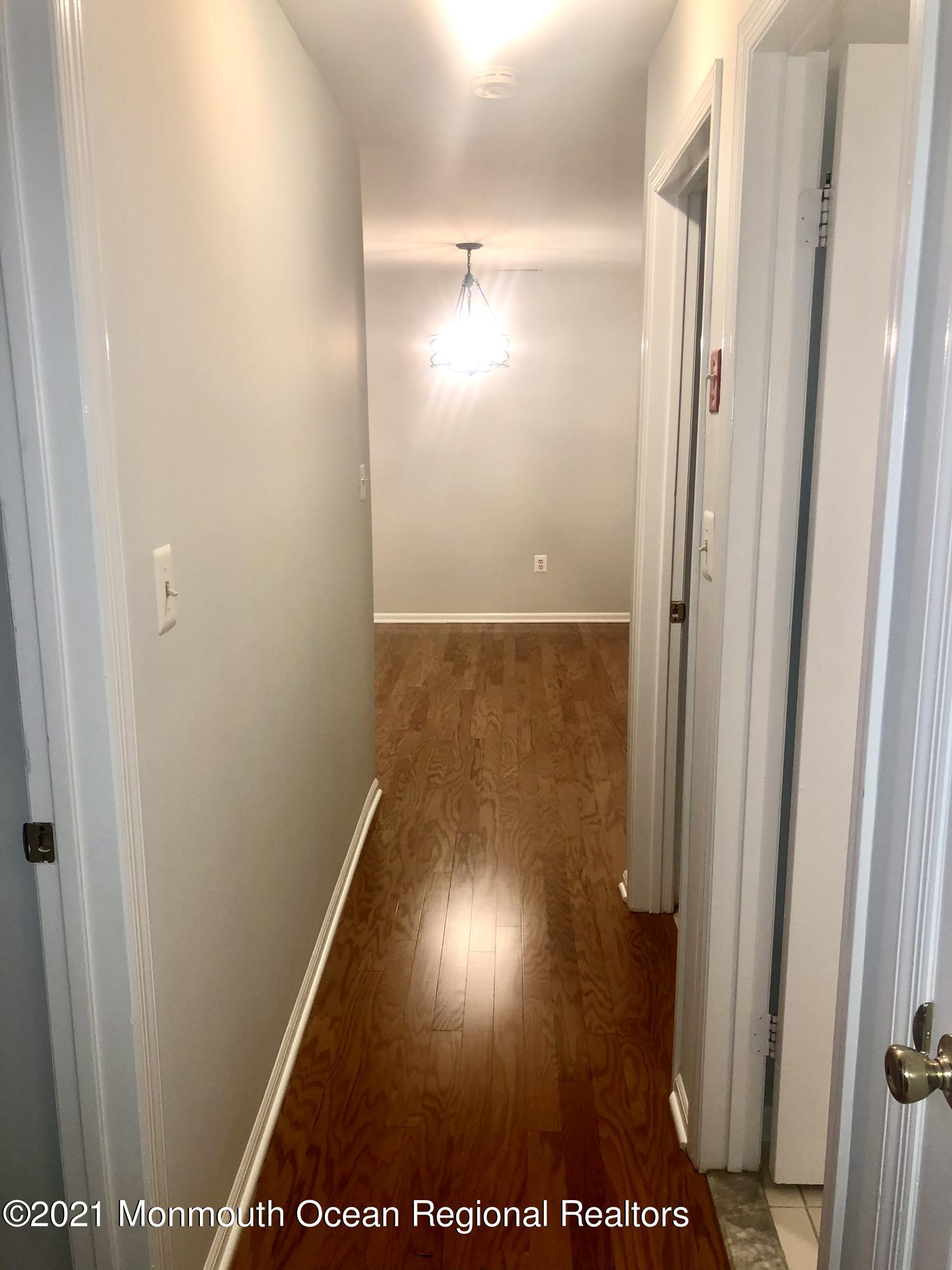 5 Racquet Road Wall, NJ 07719 - Photo 20 of 21 a view of hallway with a door and a rug