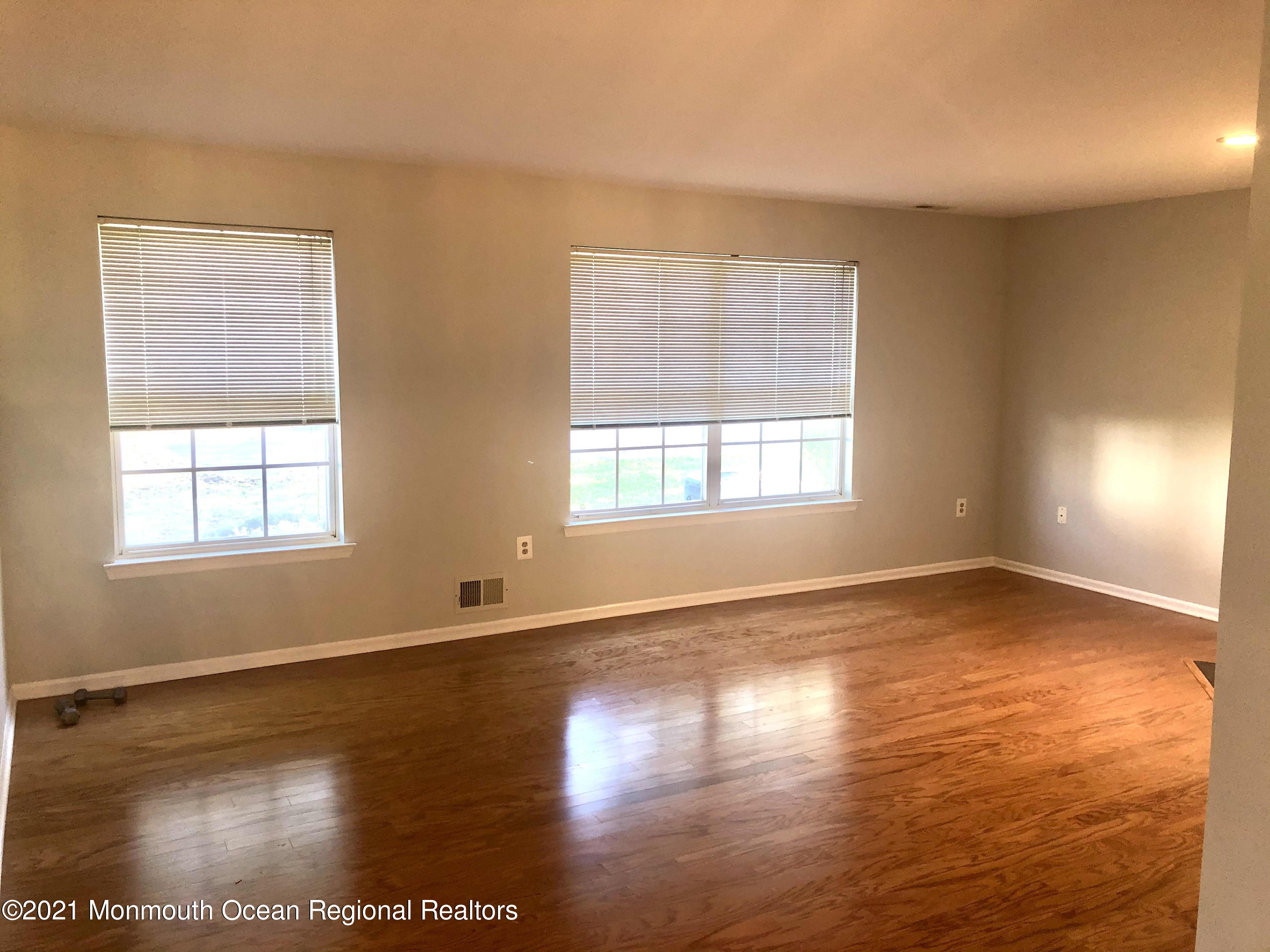 5 Racquet Road Wall, NJ 07719 - Photo 4 of 21 an empty room with wooden floor and windows