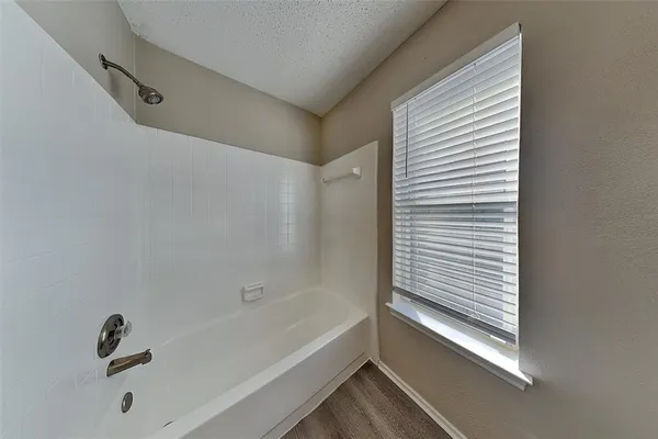 a bathroom with a tub and a shower