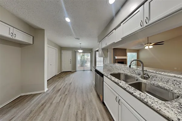a kitchen with a sink and refrigerator