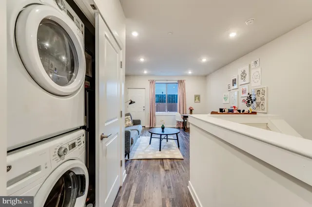 a view of a kitchen with furniture and wooden floor