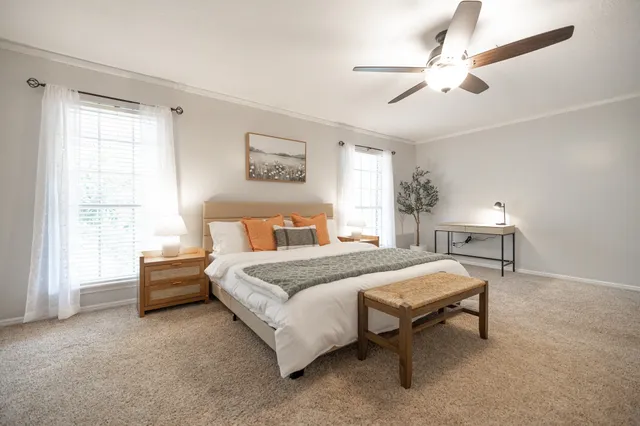 a spacious bedroom with a bed and a window