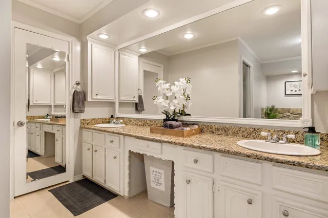 a bathroom with a sink double vanity and a mirror