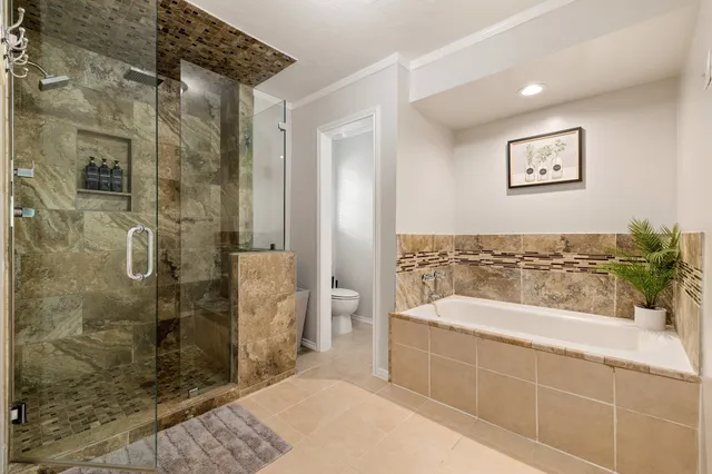 a spacious bathroom with a bathtub and shower