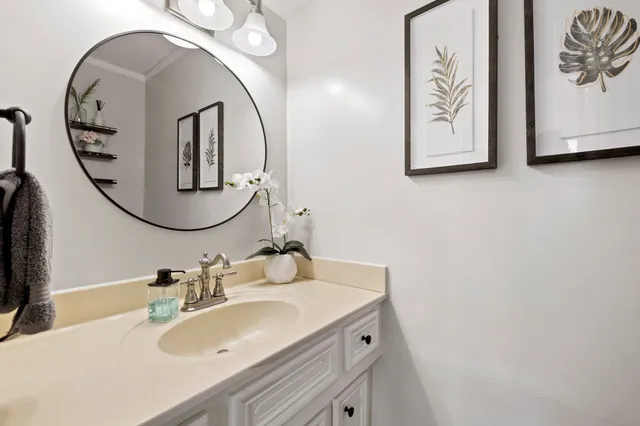 a bedroom with two beds and a chandelier