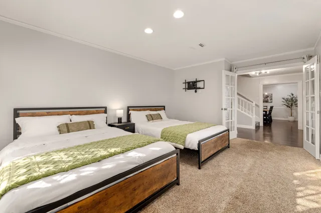 a spacious bedroom with a bed and a window