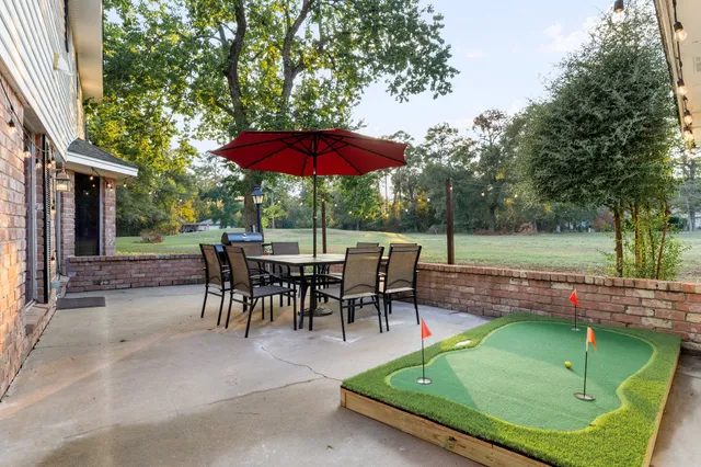 a view of backyard with seating space and trees