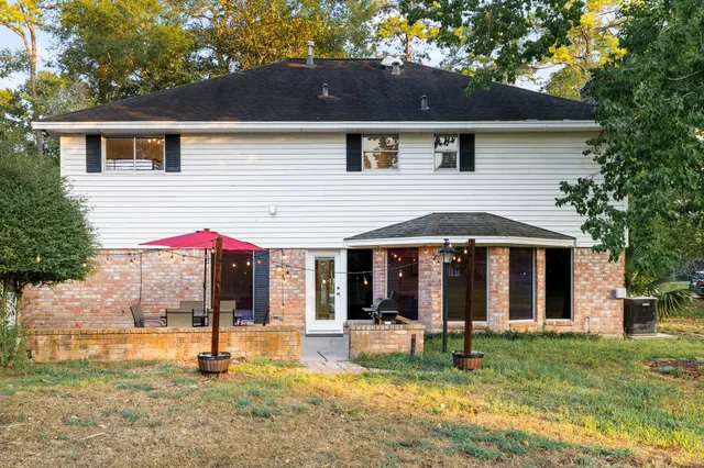 an aerial view of a house with a yard and outdoor seating