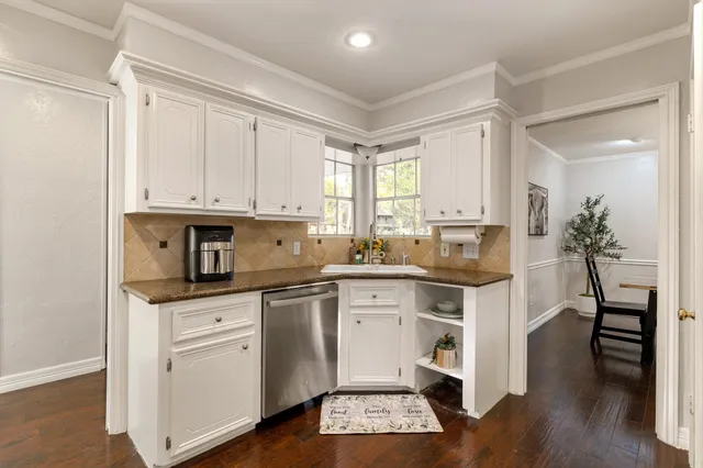 a kitchen with a sink cabinets and wooden floor