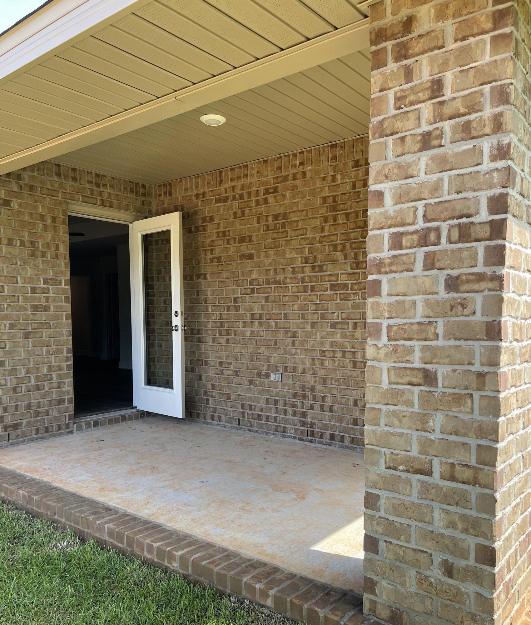 106 Ridgeway Circle Crestview, FL 32536 - Photo 13 of 25 a view of a brick house with a backyard