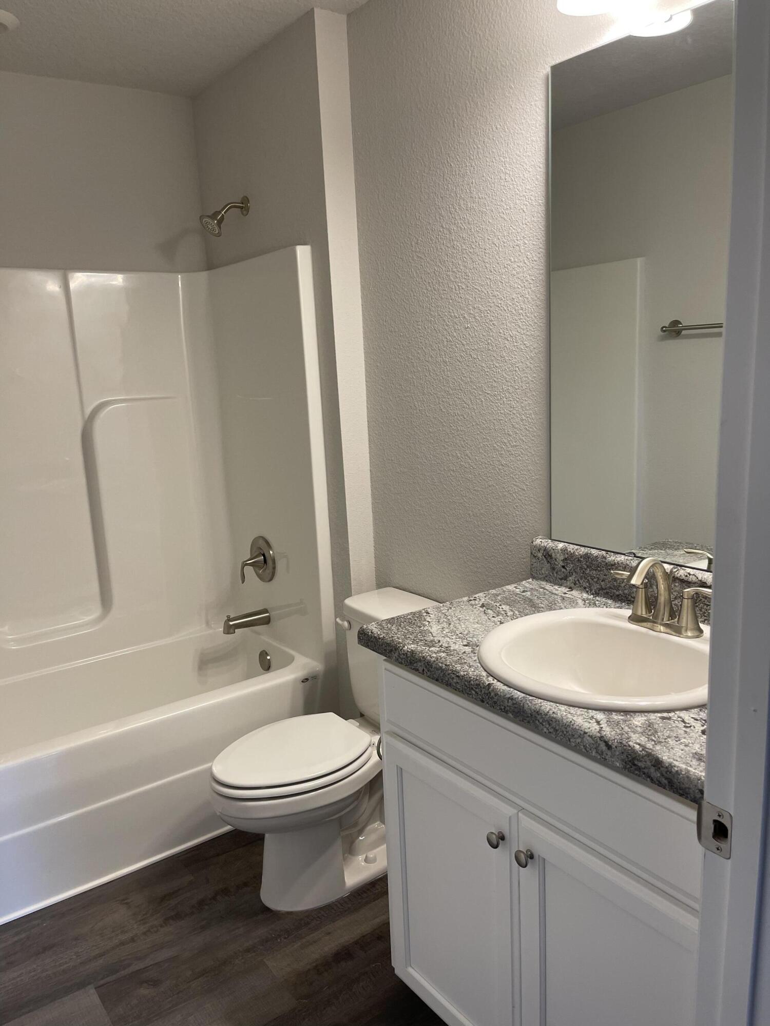 106 Ridgeway Circle Crestview, FL 32536 - Photo 14 of 25 a bathroom with a granite countertop toilet a sink and a bathtub