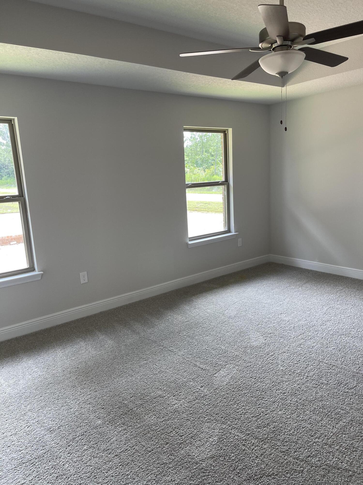 106 Ridgeway Circle Crestview, FL 32536 - Photo 17 of 25 an empty room with a window and a fan