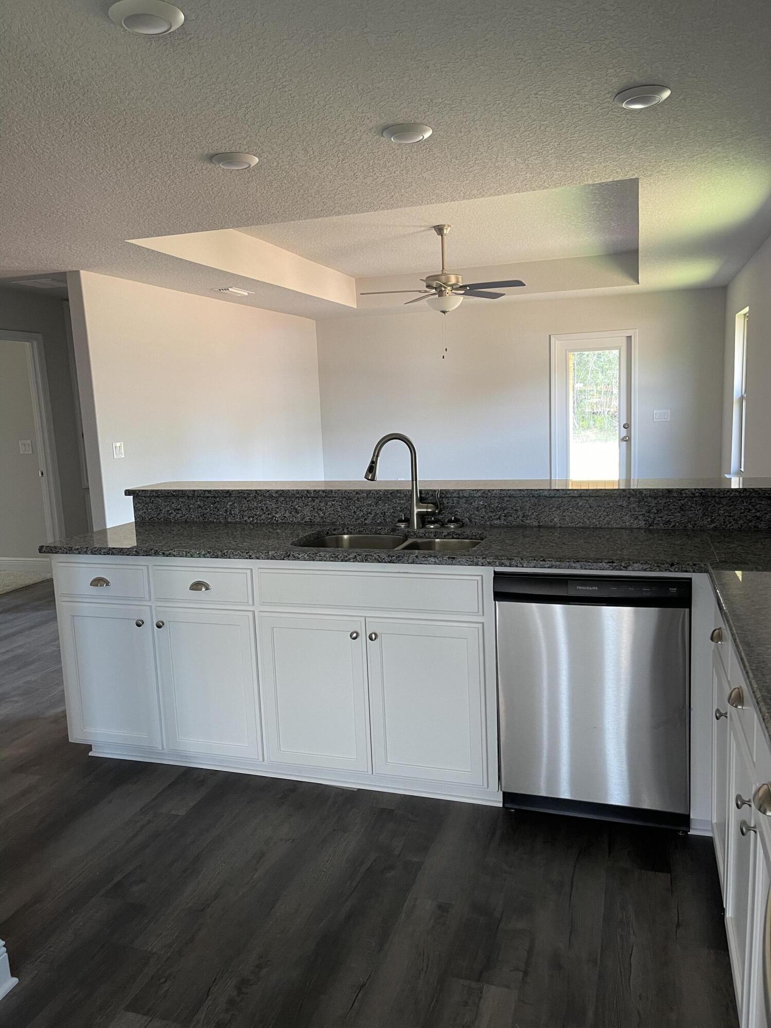 106 Ridgeway Circle Crestview, FL 32536 - Photo 7 of 25 a kitchen with granite countertop white cabinets and a sink