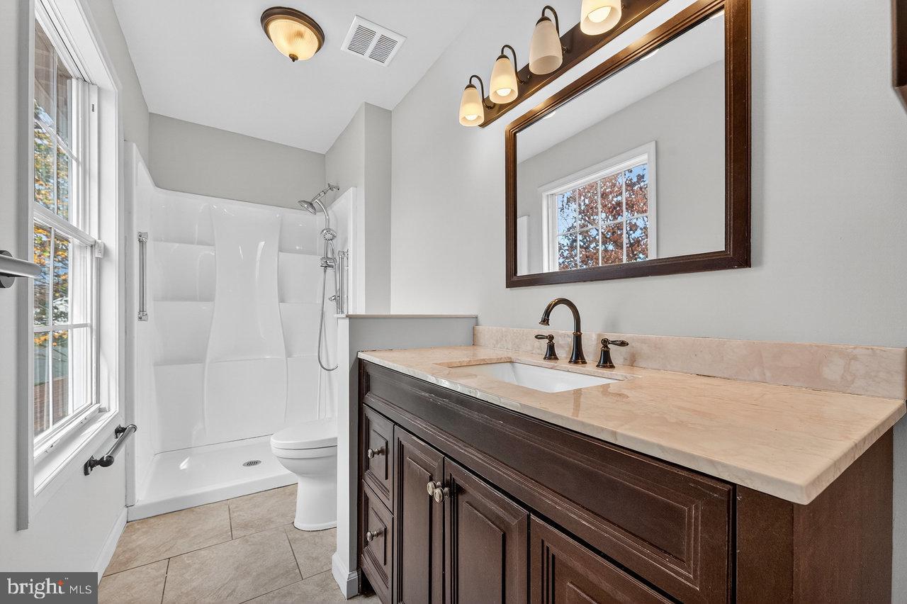 212 Chinnick Avenue Hamilton, NJ 08619 - Photo 10 of 17 a view of a bathroom with a sink and a mirror