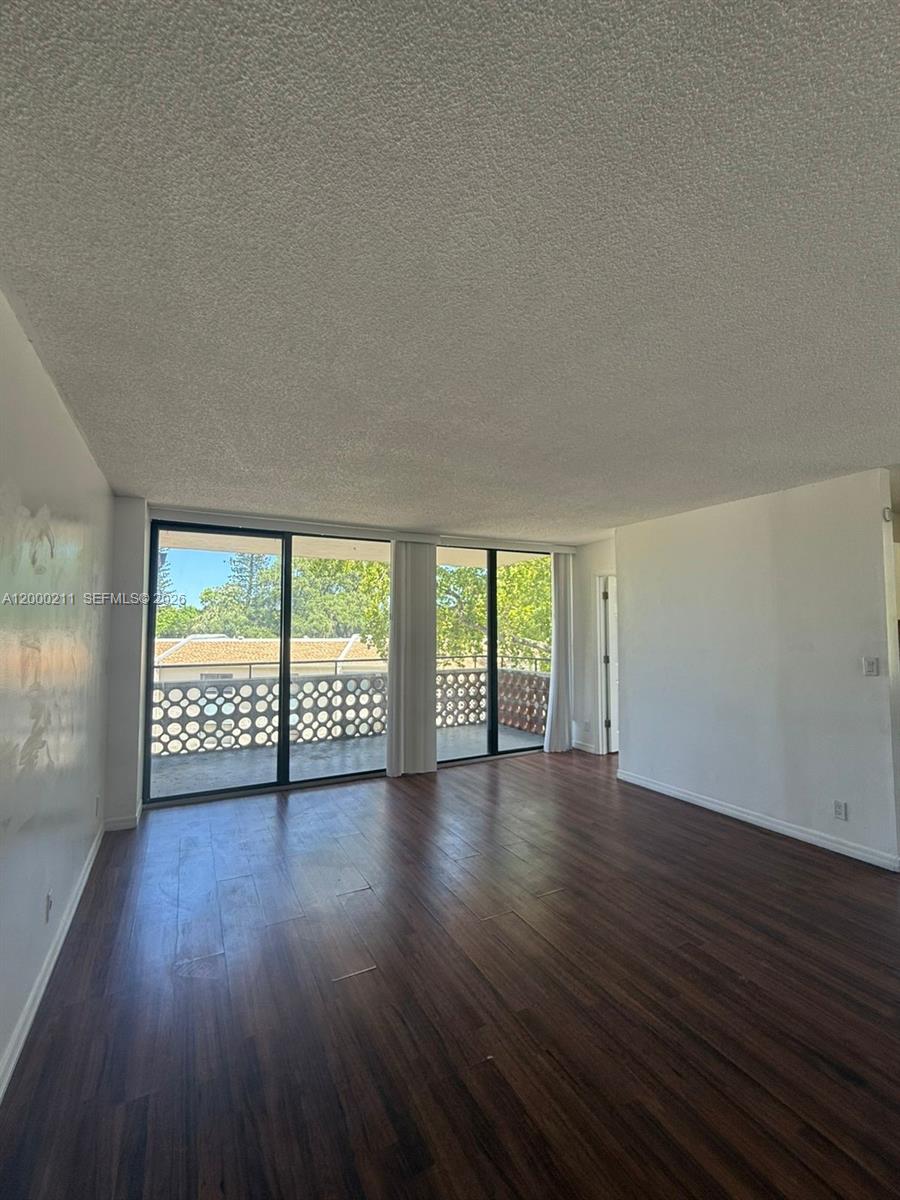 4222 Inverrary Boulevard, Unit 4215 Lauderhill, FL 33319 - Photo 15 of 20 a view of an empty room with wooden floor and a window