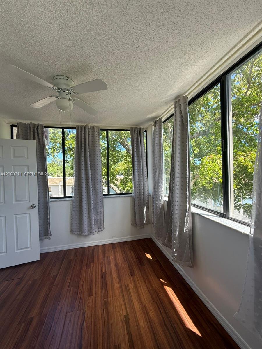 4222 Inverrary Boulevard, Unit 4215 Lauderhill, FL 33319 - Photo 20 of 20 an empty room with wooden floor and windows