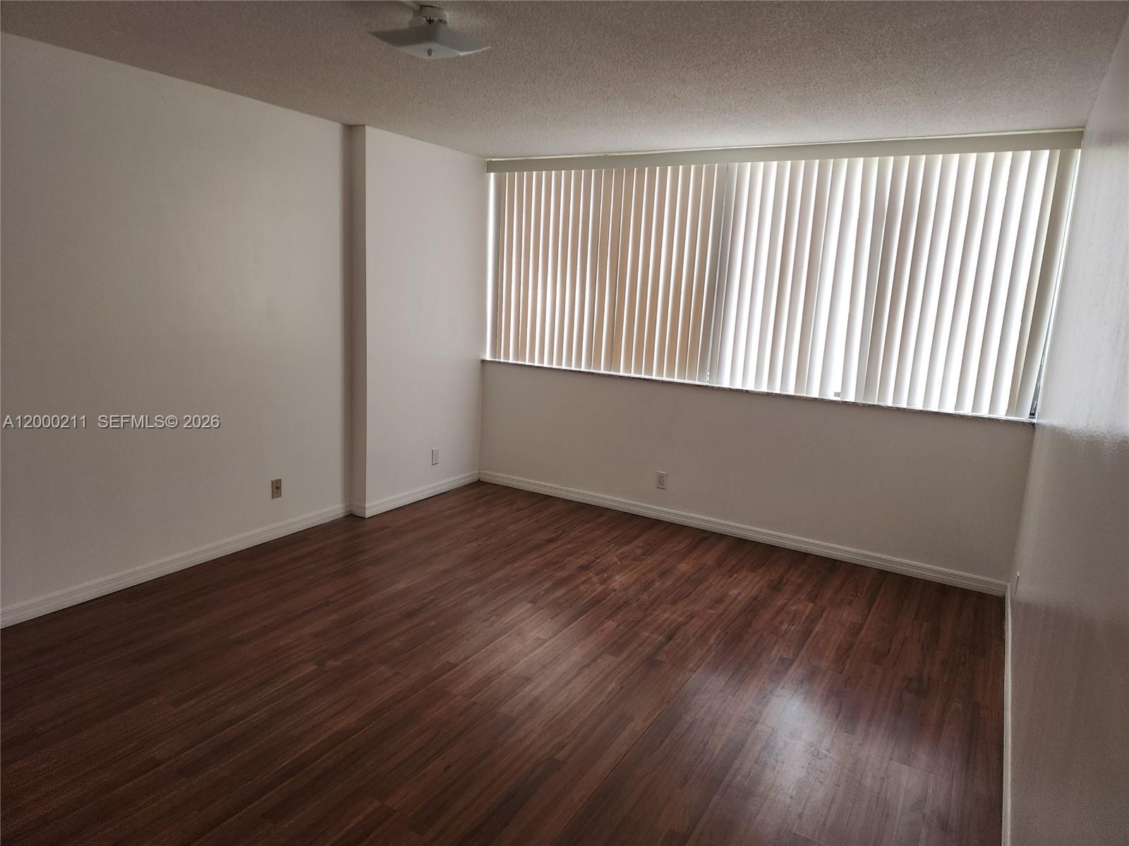 4222 Inverrary Boulevard, Unit 4215 Lauderhill, FL 33319 - Photo 3 of 20 wooden floor in an empty room with a window