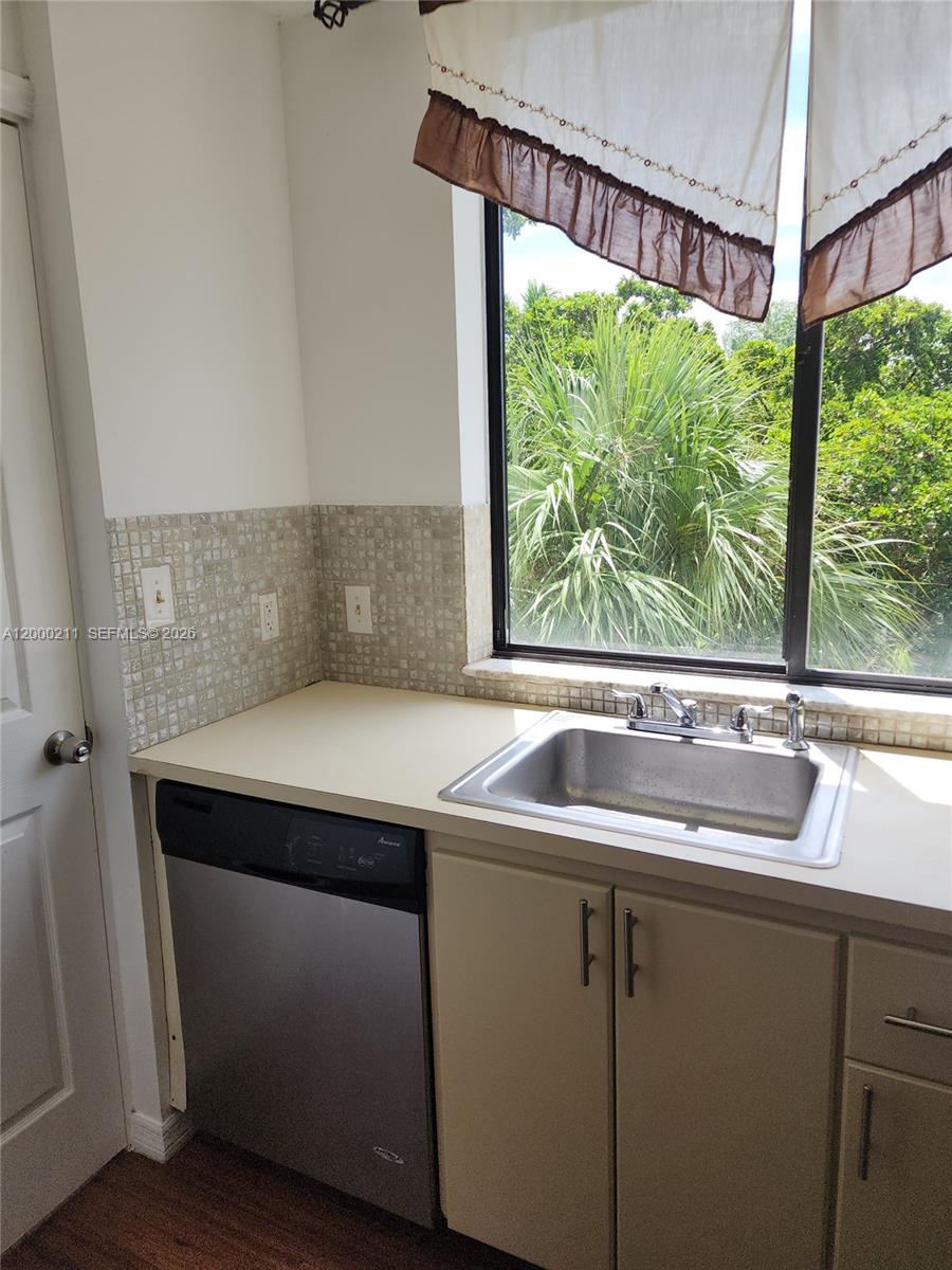 4222 Inverrary Boulevard, Unit 4215 Lauderhill, FL 33319 - Photo 5 of 20 a view of storage and utility room with washer and dryer
