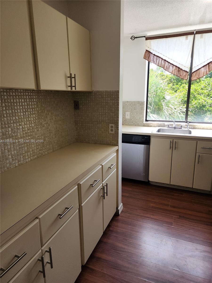 4222 Inverrary Boulevard, Unit 4215 Lauderhill, FL 33319 - Photo 6 of 20 a kitchen with stainless steel appliances granite countertop a sink a stove and a wooden floors