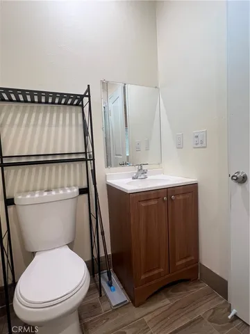a bathroom with a toilet a sink and mirror