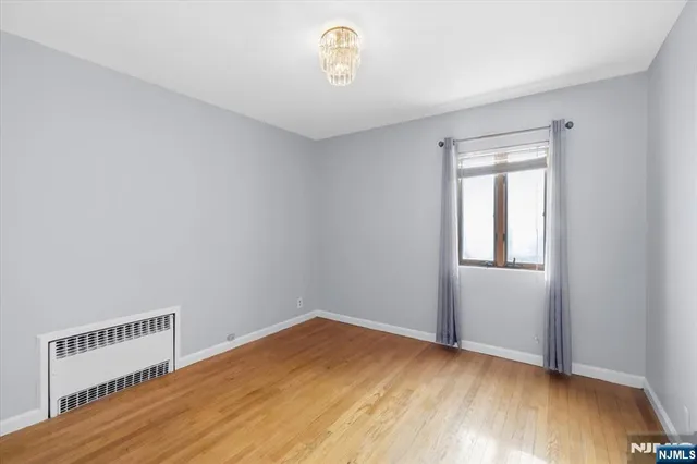 a view of a room with wooden floor and window