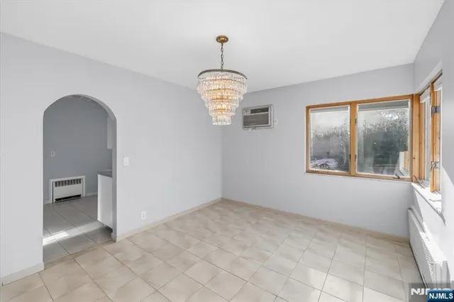 a kitchen with granite countertop white cabinets and stainless steel appliances