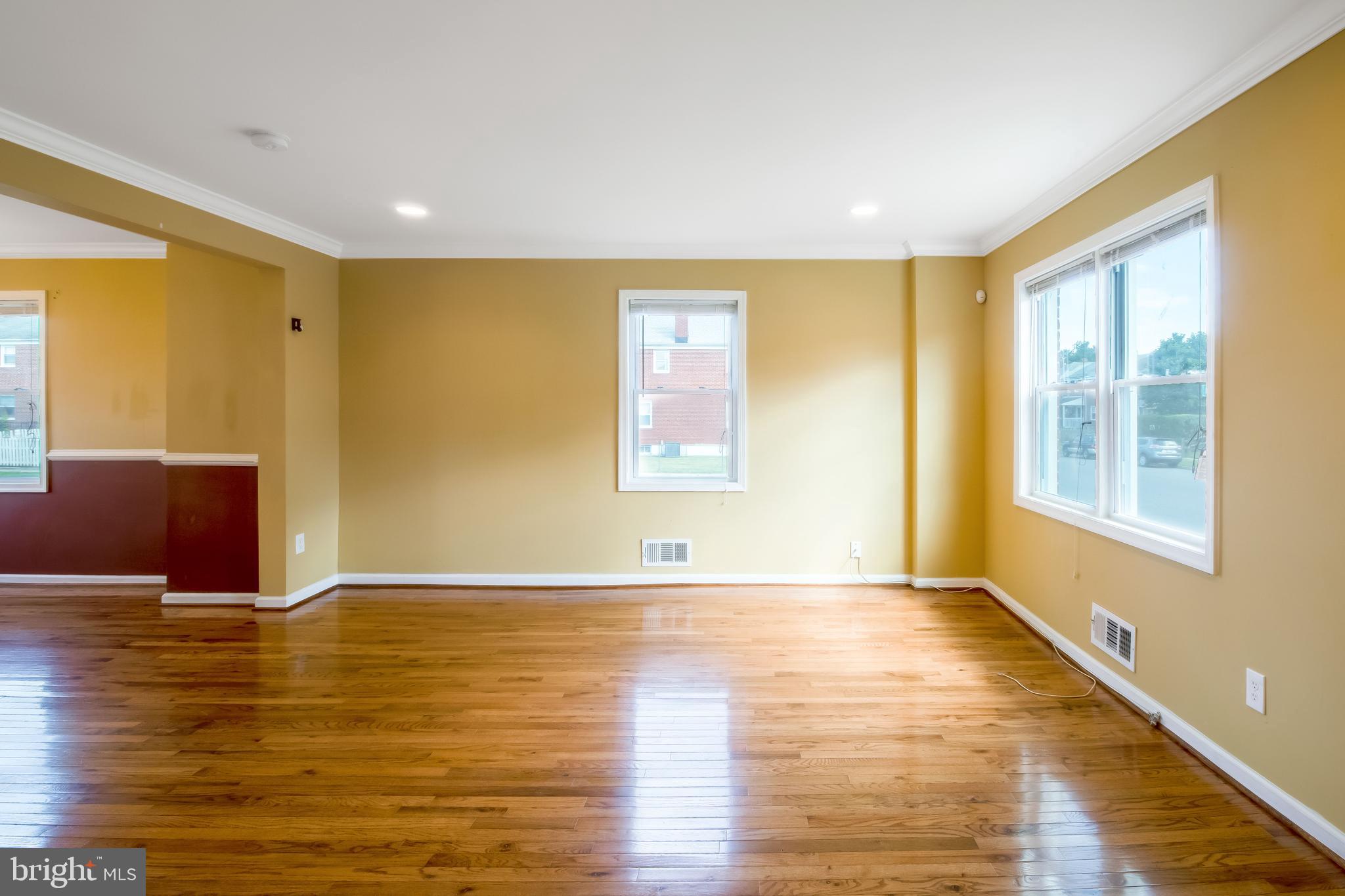 357 Grovethorn Road Baltimore, MD 21220 - Photo 8 of 34 a view of an empty room with wooden floor and a window