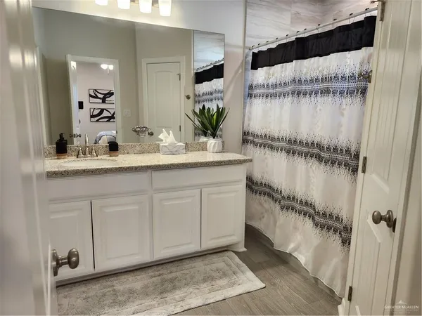 a bathroom with a sink a mirror and a shower