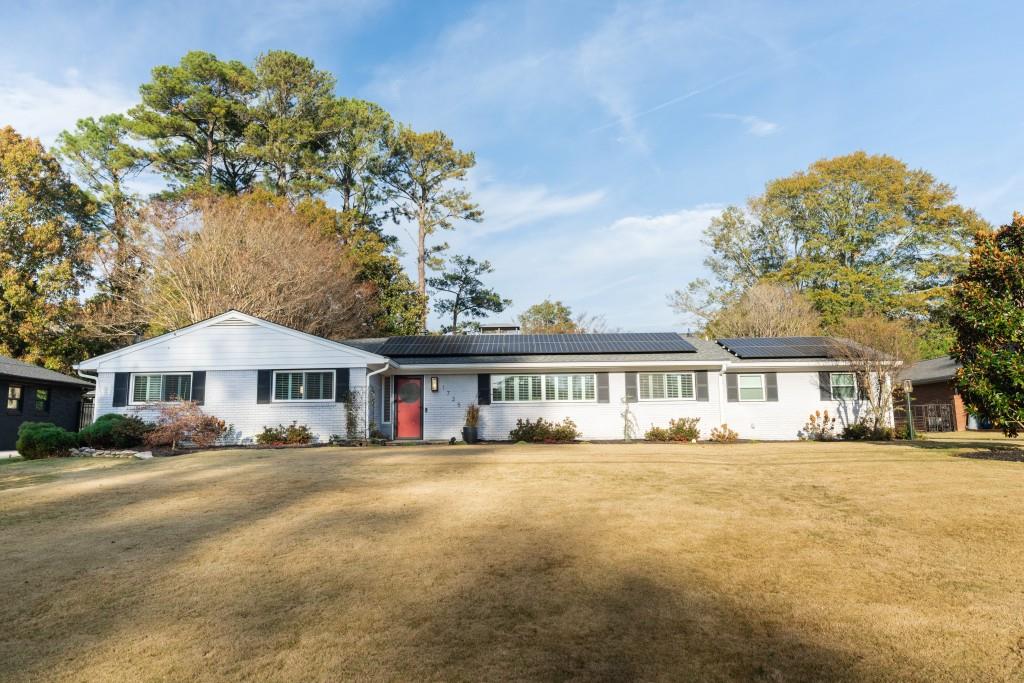 a front view of a residential apartment building with a yard