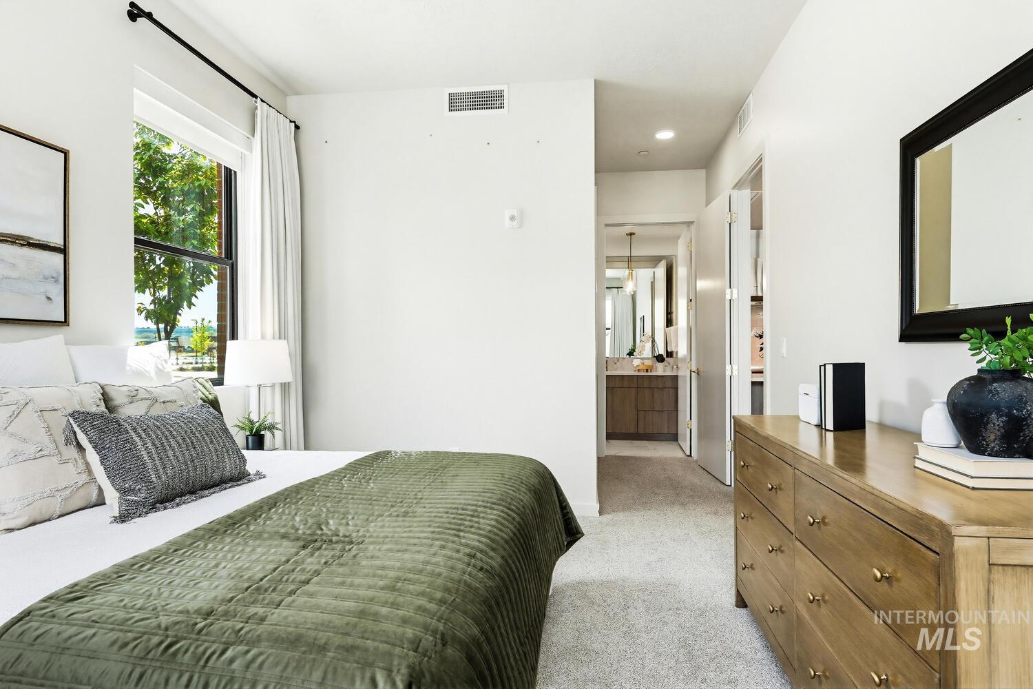 4250 Haystack, Unit 104 Boise, ID 83716 - Photo 15 of 49 Bedroom featuring connected bathroom, light carpet, and recessed lighting